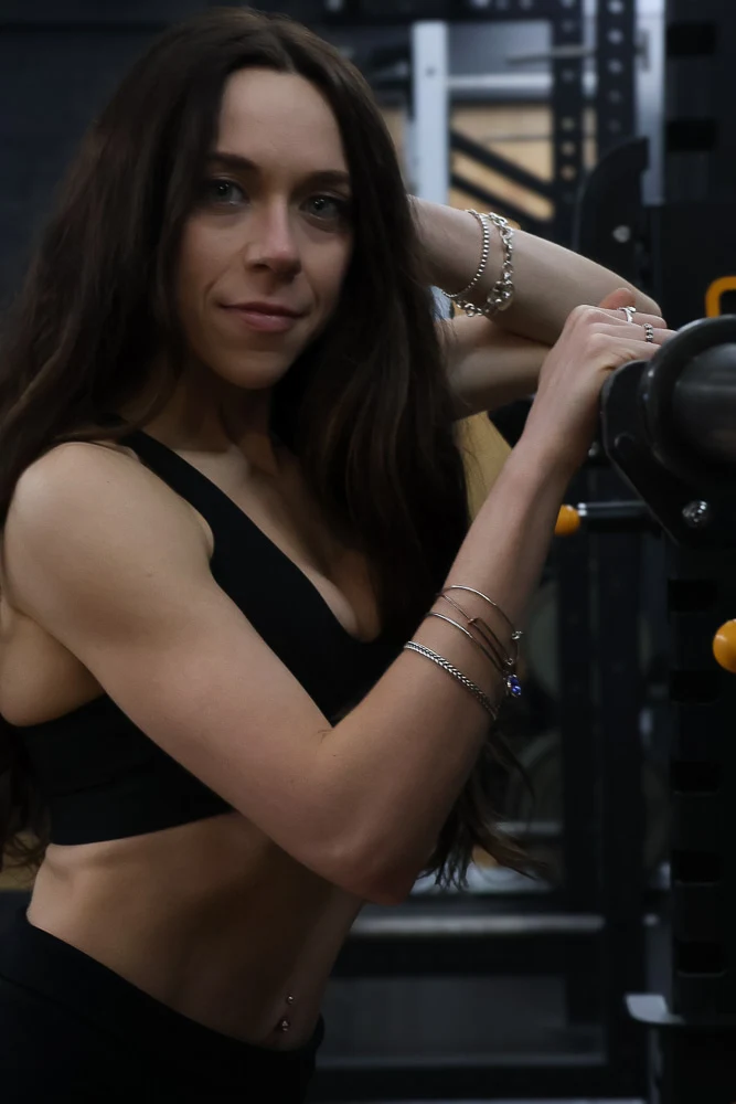 Jasmine in the gym beside a weight bench